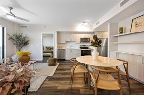 Miami apartment for rent - A modern kitchen with a dining table and chairs.