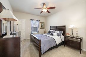 Ormond Beach apartment for rent - a bedroom with a bed and a ceiling fan