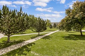 Aurora apartment for rent - A pathway in a park with trees on both sides.