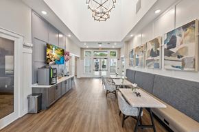 Fort Myers townhouse for rent - a living room with a table and chairs and a television
