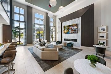 Kissimmee apartment for rent - A modern living room with a fireplace and a large painting on the wall.