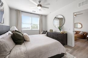 North Ft Myers apartment for rent - A bedroom with a large bed and a ceiling fan.