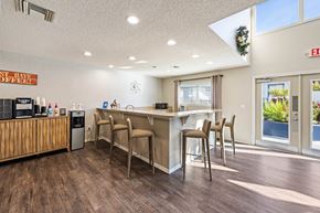 Orlando apartment for rent - a kitchen with a bar and chairs in front of a window