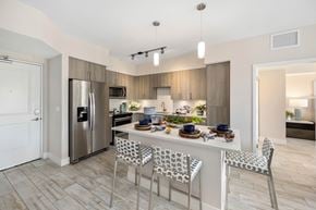 Naples apartment for rent - A modern kitchen with a dining table set for four.