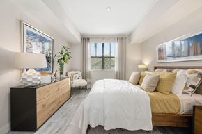 Naples apartment for rent - A bedroom with a large bed and a wooden dresser.