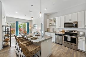 Fort Myers apartment for rent - a kitchen with stainless steel appliances and a table with chairs