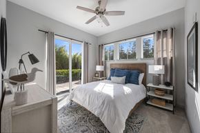 Fort Myers apartment for rent - a bedroom with a bed and a ceiling fan