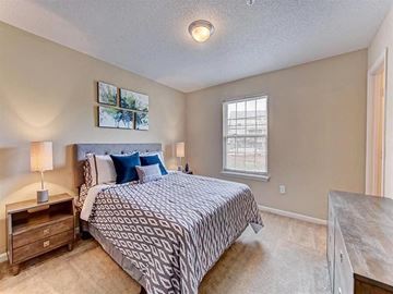 Gastonia apartment for rent - A bedroom with a large bed and a window.