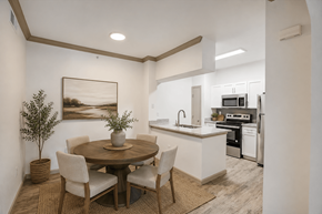 Pflugerville apartment for rent - A modern kitchen with a dining table and chairs.