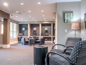 Austin apartment for rent - a lounge area with chairs and tables and a tv