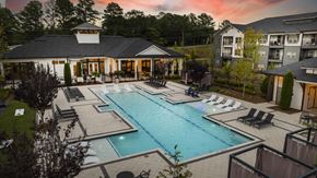 Stockbridge apartment for rent - a swimming pool with lounge chairs in front of a house
