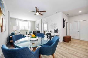 Davenport apartment for rent - A dining room with a glass table and blue chairs.