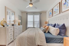 San Antonio apartment for rent - a bedroom with a bed and a ceiling fan