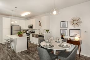 Orlando apartment for rent - A modern kitchen with a dining table set for two.