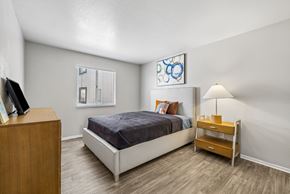 Las Vegas apartment for rent - A bedroom with a bed, nightstand, and a painting on the wall.