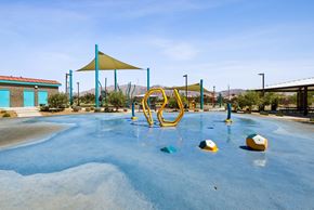 North Las Vegas apartment for rent - A playground with a blue water feature and yellow and blue play equipment.