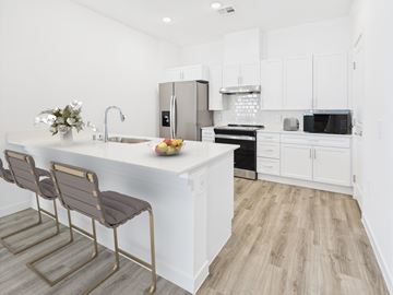 North Las Vegas apartment for rent - A kitchen with white cabinets and a wooden floor.