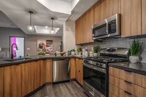 Las Vegas apartment for rent - a kitchen with stainless steel appliances and wooden cabinets