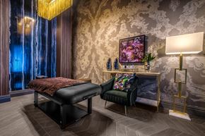 Las Vegas apartment for rent - a bedroom with a bed and a chair and a lamp