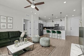 Austin apartment for rent - A modern living room with a green sofa and a coffee table.