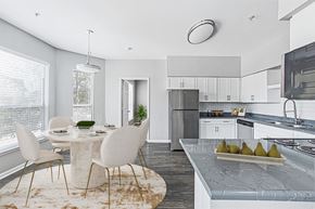 Houston apartment for rent - an open kitchen and dining room with a table and chairs