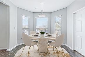 Houston apartment for rent - a dining room with a table and chairs and three windows
