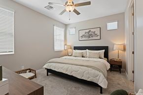 Phoenix apartment for rent - A bedroom with a large bed and a ceiling fan.