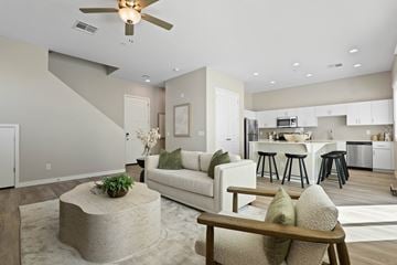 Phoenix apartment for rent - A modern living room with a white couch and a concrete coffee table.