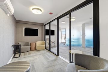Evanston apartment for rent - A living room with a television and a glass door leading to a balcony.