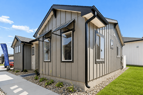 Elkhorn townhouse for rent - A modern house with a grey exterior and a black roof.