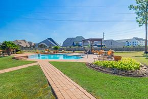 Richmond apartment for rent - A backyard with a pool and a patio area.