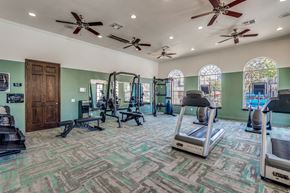 Conroe apartment for rent - A gym with treadmills, weights, and exercise equipment.