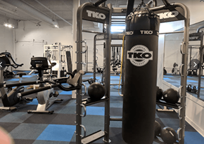 Spartanburg apartment for rent - A gym with a TKO punching bag and various exercise equipment.