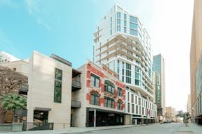 San Antonio apartment for rent - A street view of a city with buildings and a clear sky.