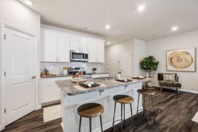 Concord townhouse for rent - A kitchen with a bar stool and a counter.