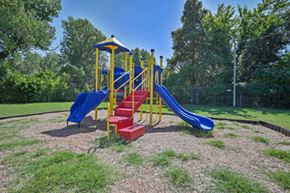 Oklahoma City apartment for rent - A playground with a blue slide and red steps.