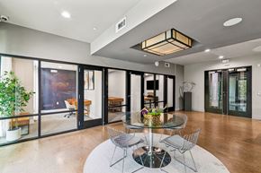 Katy apartment for rent - A modern dining room with a glass table and chairs.