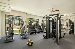 Scottsdale apartment for rent - A gym with a variety of equipment including treadmills, elliptical machines, and a weight machine.
