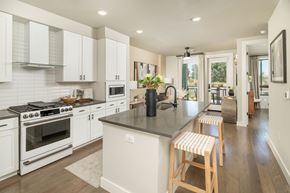 Scottsdale apartment for rent - A kitchen with white cabinets and a black countertop.
