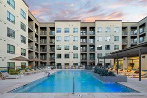Scottsdale apartment for rent - A large swimming pool in front of apartment buildings.
