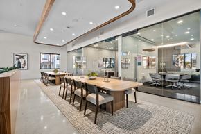 Mesa apartment for rent - A modern dining room with a long table and chairs.