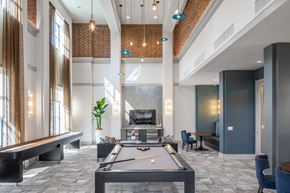Houston apartment for rent - a clubhouse with a pool table and a fireplace