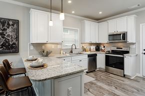 Huntsville apartment for rent - a kitchen with white cabinets and a marble counter top
