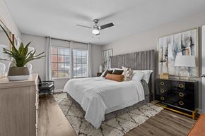 Austin apartment for rent - A bedroom with a large bed and a ceiling fan.