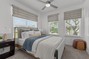 Leander apartment for rent - A bedroom with a large bed and a ceiling fan.