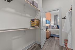 Austin apartment for rent - A small bedroom with a bed and a wardrobe.