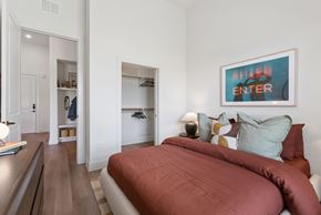 Austin apartment for rent - A bedroom with a large bed and a painting on the wall.