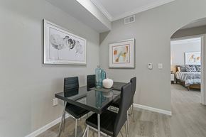 Dallas apartment for rent - a dining area with a glass table and four black chairs