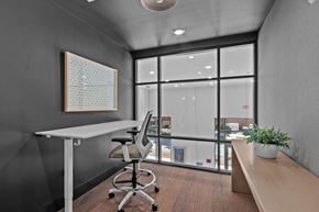 Huntersville townhouse for rent - A modern office space with a desk, chair, and a view of the outside.