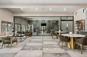 Tucson apartment for rent - A modern dining room with a glass wall and a large table.